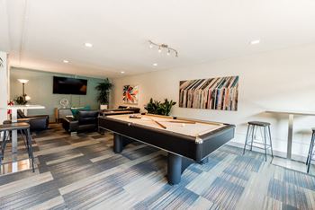a game room with a pool table and a bar